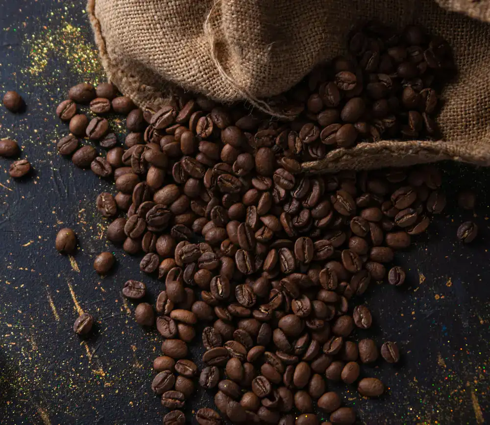 Minimalist coffee bag next to scattered beans