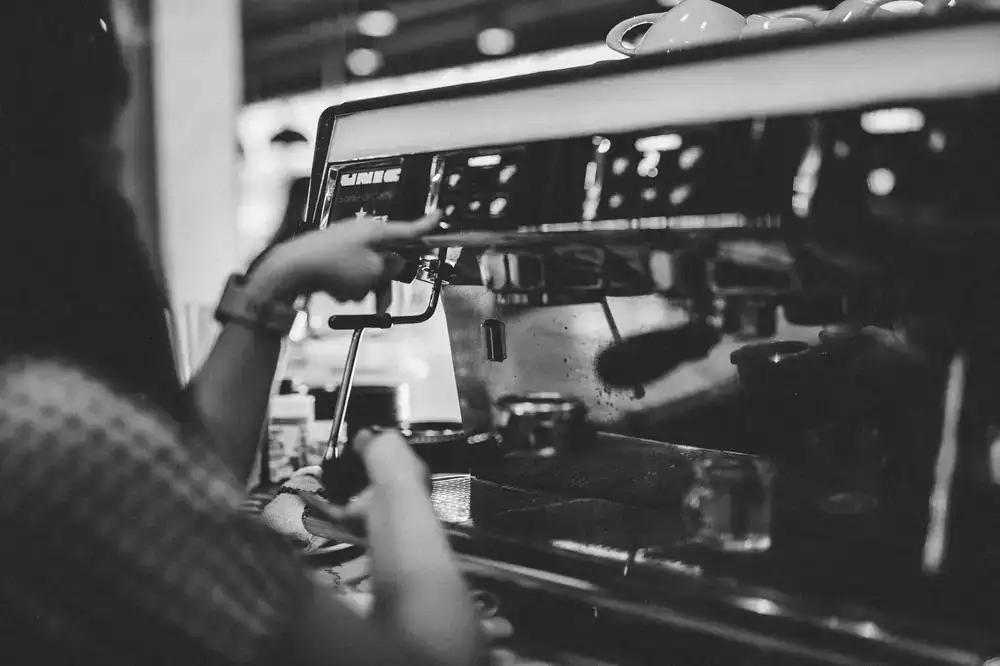 Barista pulling an espresso shot at the counter